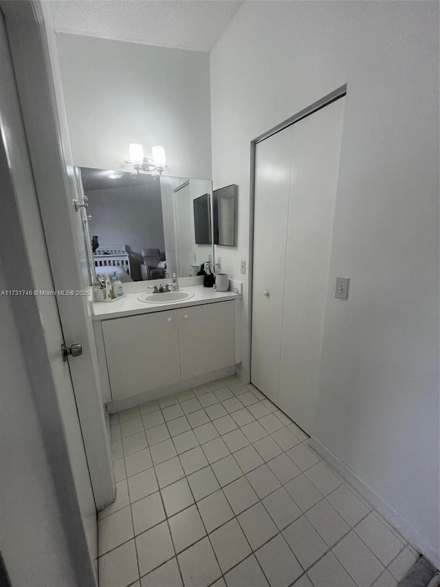 bathroom with vanity, tile patterned flooring, and a textured ceiling