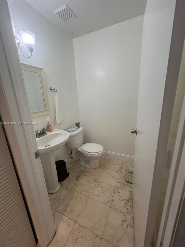 bathroom featuring sink and toilet