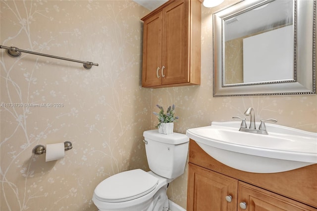 bathroom featuring vanity and toilet