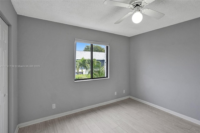 unfurnished room featuring ceiling fan, light hardwood / wood-style floors, and a textured ceiling