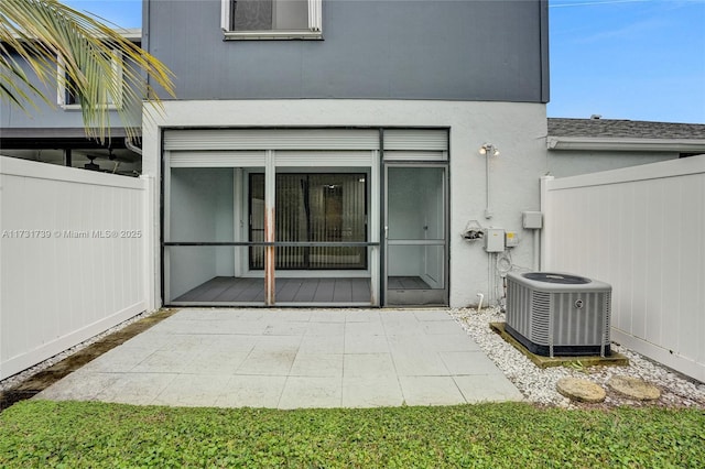 property entrance with central AC unit and a patio area