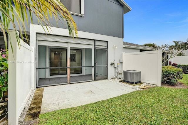 rear view of house featuring a yard, a patio, and central air condition unit