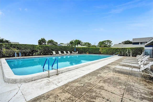 view of swimming pool featuring a patio area