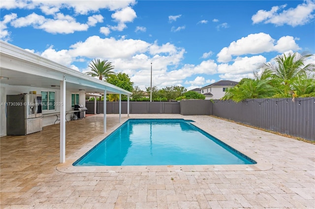 view of pool with a patio and area for grilling