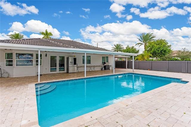 view of swimming pool featuring area for grilling and a patio