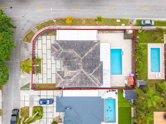 view of swimming pool featuring a patio area and a shed