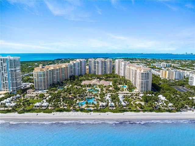 drone / aerial view featuring a beach view and a water view