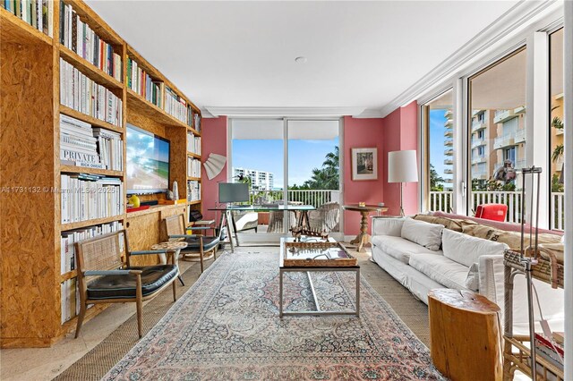 living room featuring crown molding, a healthy amount of sunlight, and floor to ceiling windows