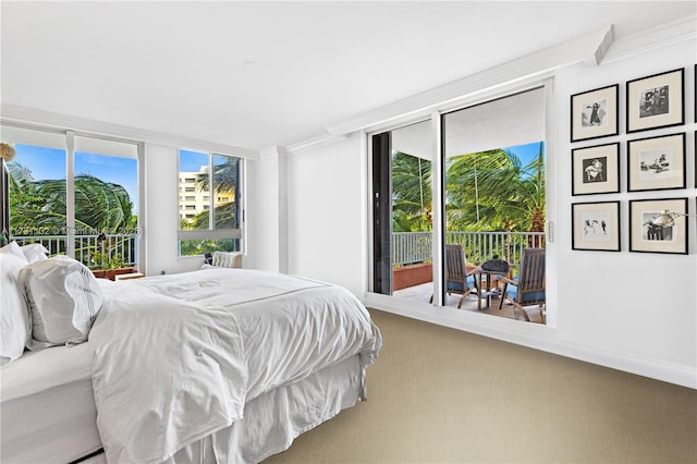 bedroom with multiple windows, access to exterior, ornamental molding, and carpet flooring