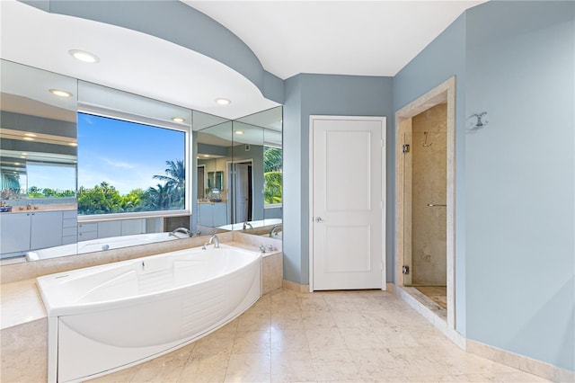 bathroom with plenty of natural light and independent shower and bath