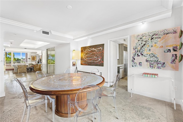 dining space with ornamental molding