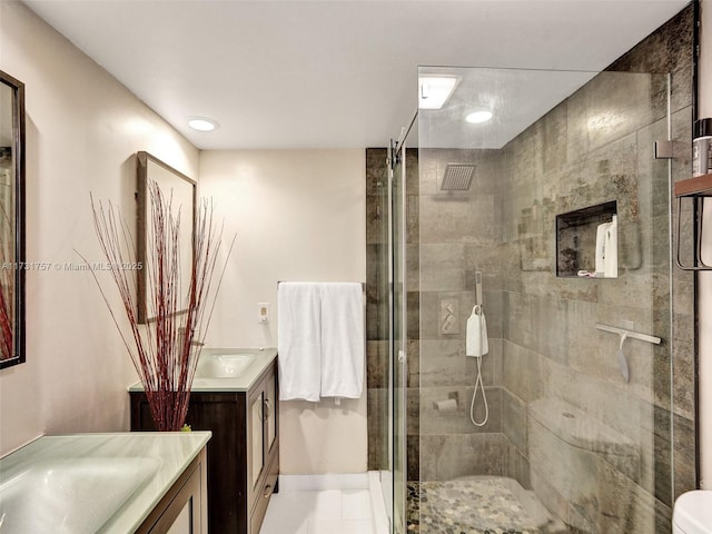 bathroom featuring vanity and a shower with shower door