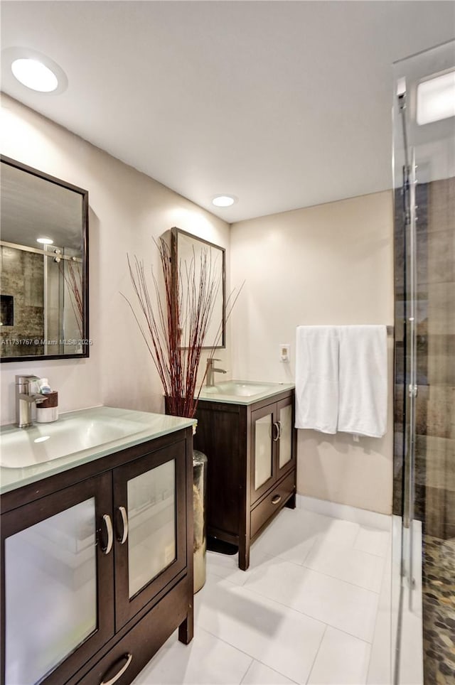 bathroom with vanity, a shower with shower door, and tile patterned flooring