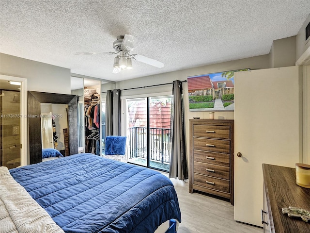 bedroom with a spacious closet, access to outside, light hardwood / wood-style floors, ceiling fan, and a closet