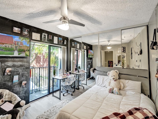 bedroom featuring ceiling fan, a textured ceiling, a closet, and access to outside