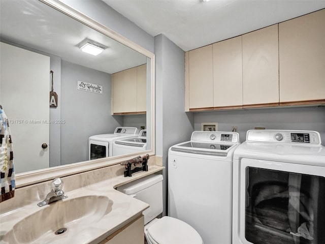 washroom with sink and washing machine and clothes dryer