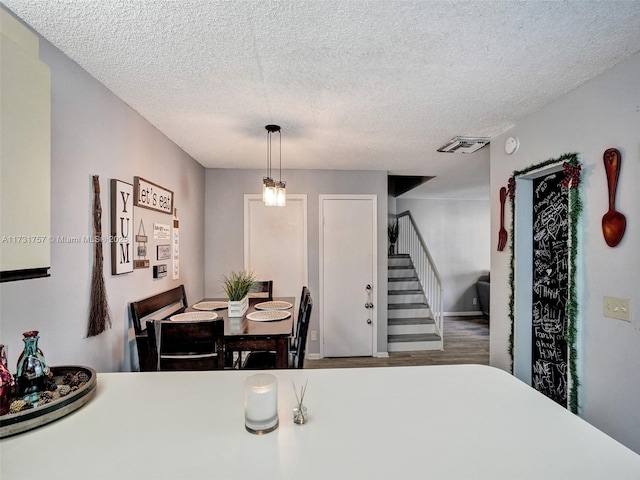 dining room featuring a textured ceiling