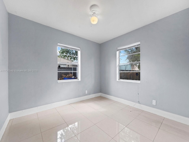 spare room featuring light tile patterned flooring