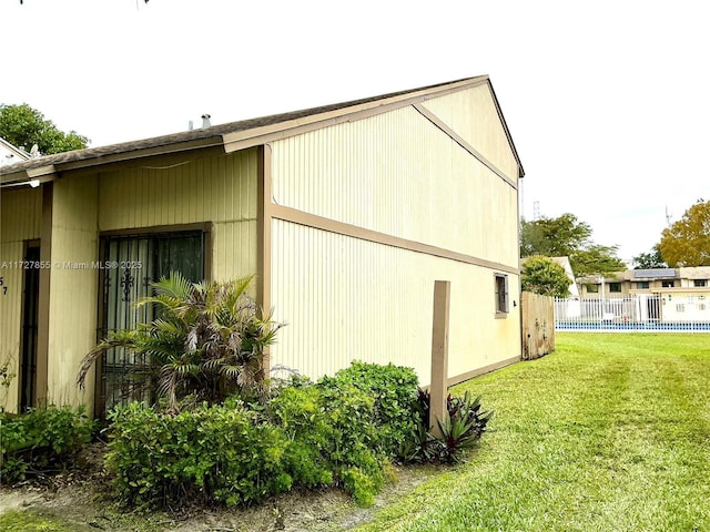 view of property exterior featuring a lawn