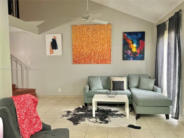 living room featuring light tile patterned flooring, ceiling fan, and lofted ceiling