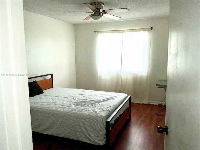 bedroom featuring ceiling fan and dark hardwood / wood-style flooring