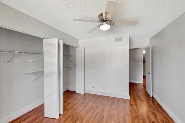 stairway with a textured ceiling, tile patterned floors, and ceiling fan