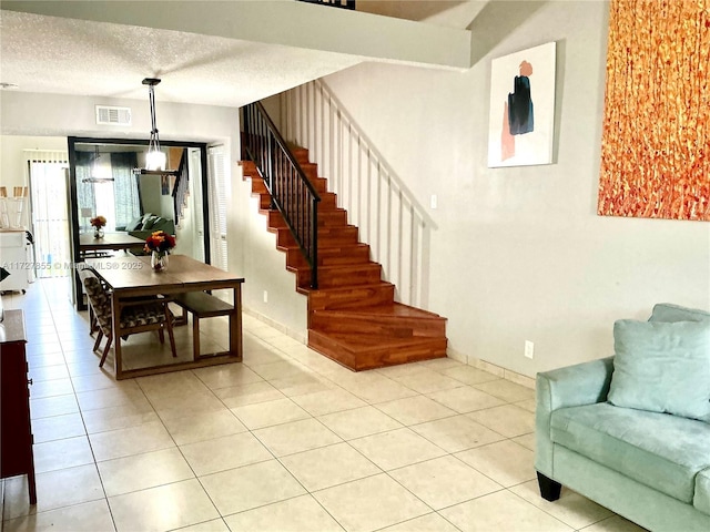 interior space featuring tile patterned floors and a textured ceiling