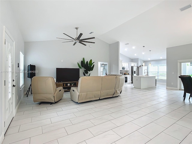 living room with ceiling fan and vaulted ceiling