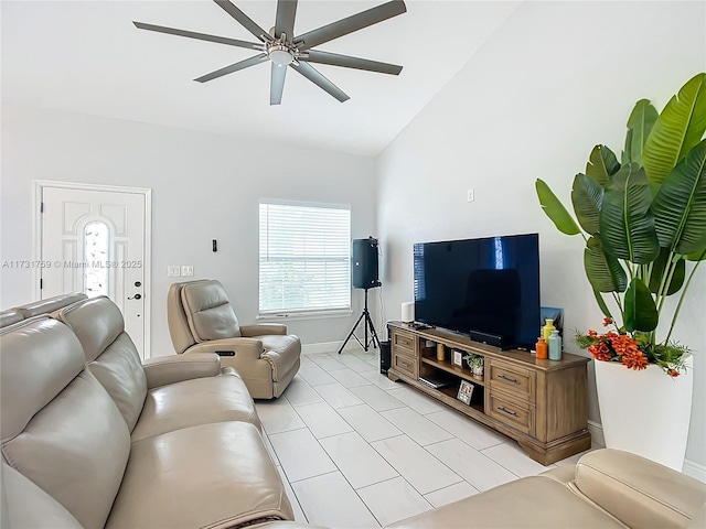 living room featuring lofted ceiling, light tile patterned floors, and ceiling fan