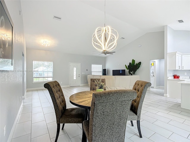 dining space featuring lofted ceiling, a chandelier, and light tile patterned floors