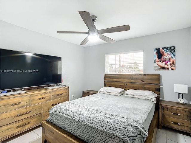 tiled bedroom featuring ceiling fan