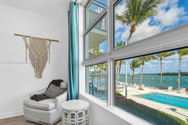 interior space with hardwood / wood-style flooring and a water view