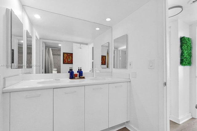 bathroom featuring vanity and hardwood / wood-style floors