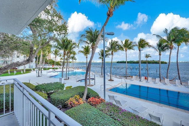 view of swimming pool with a water view