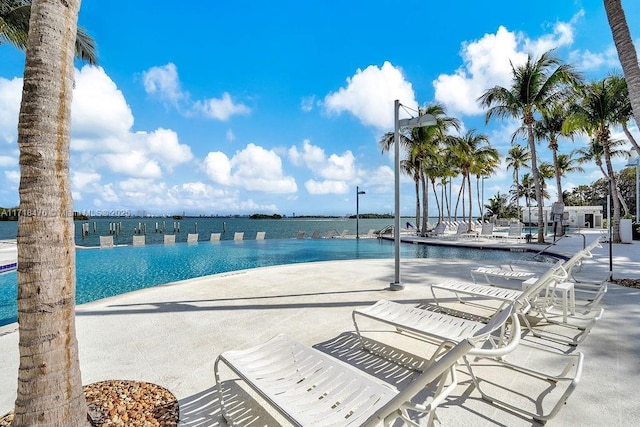 view of swimming pool featuring a water view