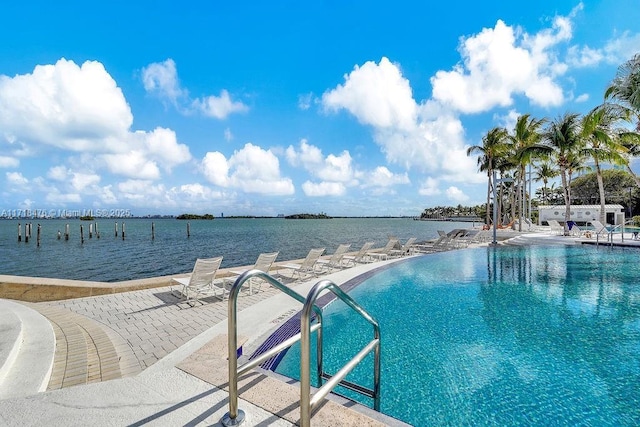 view of swimming pool with a water view