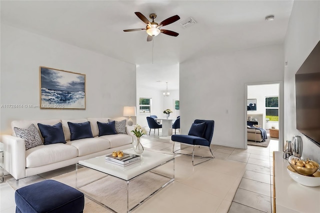 tiled living room featuring vaulted ceiling and ceiling fan