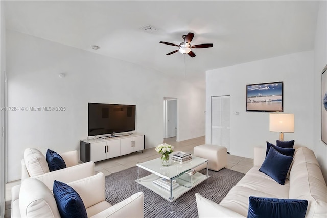 living room with ceiling fan and light tile patterned floors