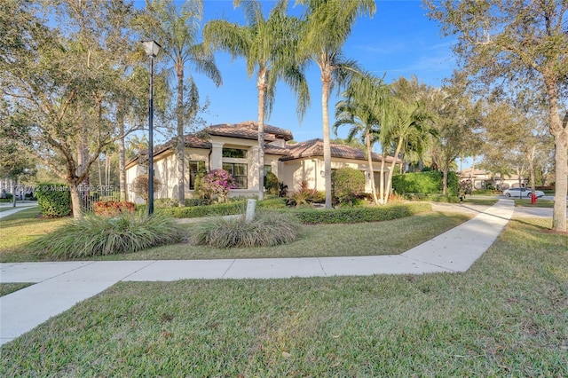 mediterranean / spanish-style home featuring a front lawn