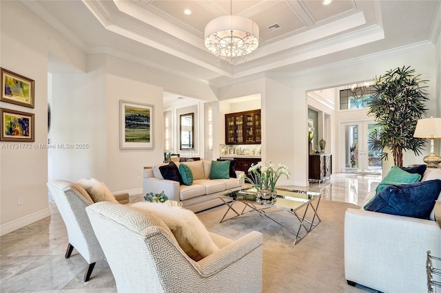 living room featuring crown molding, an inviting chandelier, and french doors