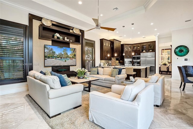 living room with ornamental molding and ceiling fan