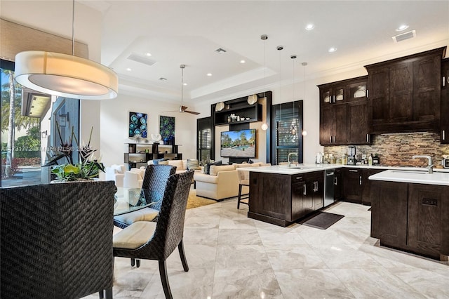 kitchen featuring sink, dark brown cabinets, and pendant lighting