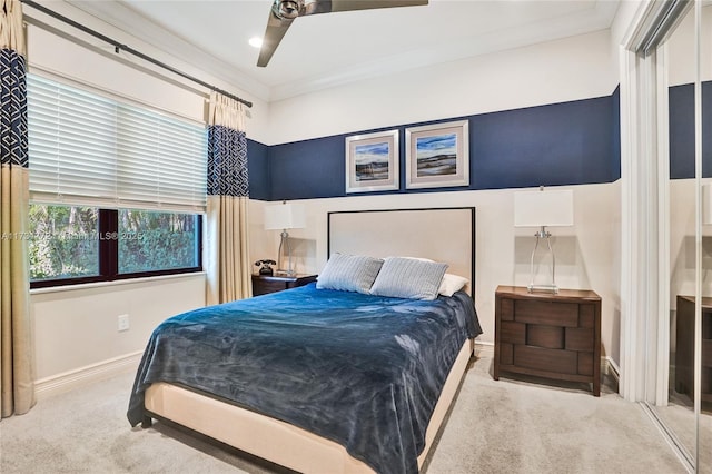 bedroom featuring crown molding, carpet floors, and ceiling fan