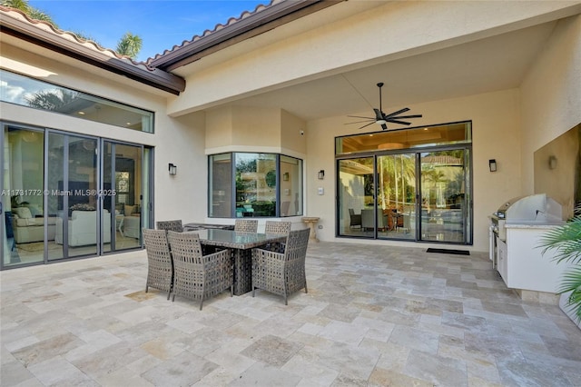 view of patio with an outdoor kitchen and ceiling fan