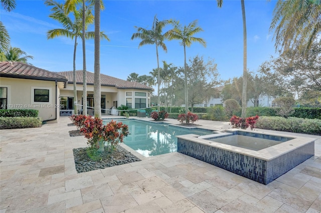 view of pool featuring a patio and an in ground hot tub