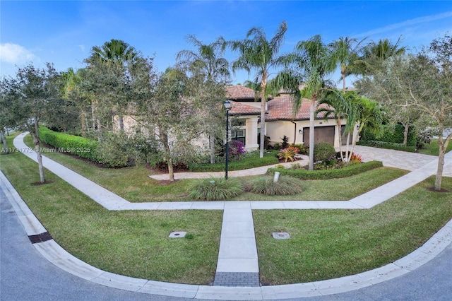 view of front of home featuring a garage and a front lawn