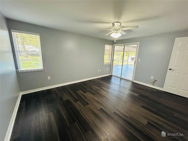 2013 Finland Dr, Spring Hill, FL 34609 - unfurnished room with dark wood-type flooring, ceiling fan, and plenty of natural light