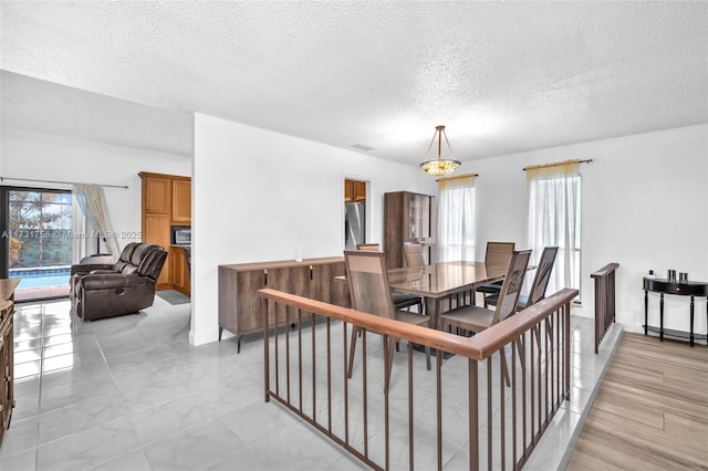 dining room featuring a textured ceiling