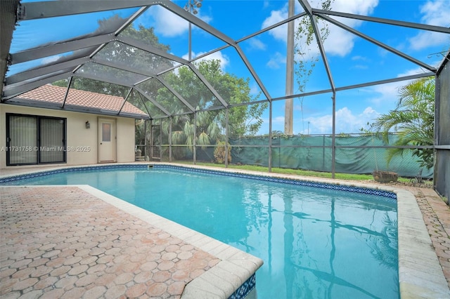 view of pool with a patio and a lanai