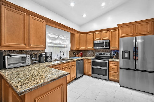 kitchen featuring sink, dark stone countertops, backsplash, stainless steel appliances, and vaulted ceiling